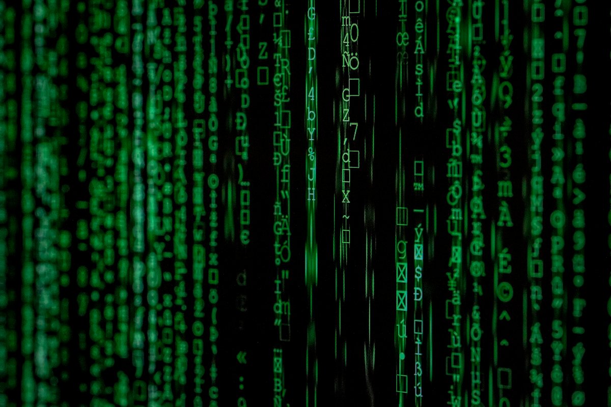 Green code on a dark screen representing cybersecurity monitoring